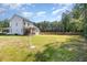 Spacious backyard with ample green space and a view of the home's exterior; perfect for outdoor activities at 454 Martins Mill Ct, Wendell, NC 27591