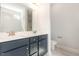 Bathroom with double sink vanity, dark blue cabinets, and modern fixtures at 454 Martins Mill Ct, Wendell, NC 27591