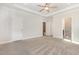 Empty bedroom with carpet, ceiling fan, and large windows offering ample natural light at 454 Martins Mill Ct, Wendell, NC 27591