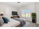 Nicely staged bedroom featuring ample lighting, carpet, and modern decor at 454 Martins Mill Ct, Wendell, NC 27591