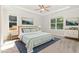 Staged bedroom with carpet, ceiling fan, and large windows offering ample natural light at 454 Martins Mill Ct, Wendell, NC 27591