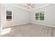 Spacious bedroom with carpet, ceiling fan, and large windows offering ample natural light at 454 Martins Mill Ct, Wendell, NC 27591