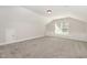 Bright bonus room featuring natural lighting, neutral walls and carpet at 454 Martins Mill Ct, Wendell, NC 27591