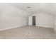 Bright bonus room featuring neutral carpet, and a doorway providing a view to another room at 454 Martins Mill Ct, Wendell, NC 27591