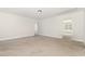 Large bonus room features neutral carpet and natural lighting at 454 Martins Mill Ct, Wendell, NC 27591