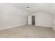 Spacious bonus room with natural lighting, neutral walls and carpet, and an open doorway at 454 Martins Mill Ct, Wendell, NC 27591