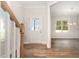 Bright foyer with hardwood flooring, a staircase and an entry door leading to a light-filled dining room at 454 Martins Mill Ct, Wendell, NC 27591