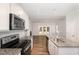 Modern kitchen with granite countertops, stainless steel appliances, and an open layout to living space at 454 Martins Mill Ct, Wendell, NC 27591