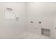 Bright laundry room featuring neutral walls and floors, and washer/dryer hookups at 454 Martins Mill Ct, Wendell, NC 27591