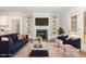 Bright living room featuring built-in shelving, fireplace, wood floors, and stylish contemporary furnishings at 454 Martins Mill Ct, Wendell, NC 27591