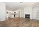 Open layout with a kitchen featuring stainless appliances and a living room with fireplace and built-in shelving at 454 Martins Mill Ct, Wendell, NC 27591