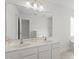 Bright bathroom featuring a large vanity with double sinks and a huge mirror at 4716 Miller Dr, Durham, NC 27704