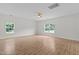 Bedroom with hardwood floors and windows overlooking the lawn at 4716 Miller Dr, Durham, NC 27704