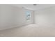 Neutral bedroom with window providing natural light and a neighborhood view at 4716 Miller Dr, Durham, NC 27704