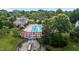 Aerial view of a community pool, playground and clubhouse surrounded by mature trees and landscaping at 4716 Miller Dr, Durham, NC 27704