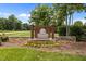 Entrance sign for Swann's Mill community with stone base, flowers and landscaping at 4716 Miller Dr, Durham, NC 27704
