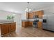 Modern kitchen with wood cabinets, stainless steel appliances, and granite countertops for cooking enjoyment at 4716 Miller Dr, Durham, NC 27704
