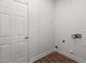 Bright laundry room features wood-look vinyl flooring and utility connections at 4716 Miller Dr, Durham, NC 27704