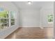 Bright Living Room with hard wood floors and windows overlooking the lawn at 4716 Miller Dr, Durham, NC 27704