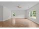 Spacious living room features wood-look flooring, ceiling fan, and large windows, perfect for relaxation and entertainment at 4716 Miller Dr, Durham, NC 27704