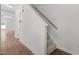 Carpeted staircase in a house with hardwood floors and white walls at 4716 Miller Dr, Durham, NC 27704