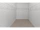 Walk-in closet with wire shelving and neutral carpet is ready for all of your storage needs at 4716 Miller Dr, Durham, NC 27704