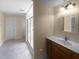 Bright bathroom featuring a vanity with a white countertop and a glass-enclosed shower at 495 Ruth Cir, Fuquay Varina, NC 27526