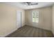 Bedroom boasts neutral walls and carpet, complemented by plantation shutters at 495 Ruth Cir, Fuquay Varina, NC 27526