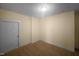 A small bedroom with hardwood floors and a white door at 495 Ruth Cir, Fuquay Varina, NC 27526