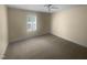 Neutral bedroom with a ceiling fan and window bringing in natural light at 495 Ruth Cir, Fuquay Varina, NC 27526