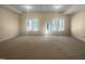 Large bonus room with neutral carpet, natural light, and a door to the outside at 495 Ruth Cir, Fuquay Varina, NC 27526