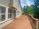 Spacious wooden deck offers an inviting outdoor space with a view of the lush surrounding greenery at 495 Ruth Cir, Fuquay Varina, NC 27526
