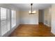 Elegant dining room with hardwood floors and natural lighting from the window at 495 Ruth Cir, Fuquay Varina, NC 27526