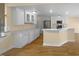 Bright kitchen featuring white cabinets, stainless steel appliances, and an island at 495 Ruth Cir, Fuquay Varina, NC 27526