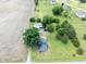 Aerial view of a house with a large tree near the driveway, garage, and grassy lawn at 5004 Us 70 Alt, Princeton, NC 27569
