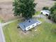 A high angle aerial view of the home on a large lot with a detached garage, yard and mature trees at 5004 Us 70 Alt, Princeton, NC 27569