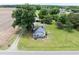 Aerial view of a charming home on a large lot with mature trees and a detached garage at 5004 Us 70 Alt, Princeton, NC 27569