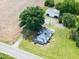 A high angle aerial view of the home on a large lot with a detached garage and mature trees at 5004 Us 70 Alt, Princeton, NC 27569
