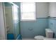 Retro bathroom with a blue-tile shower, window, and matching toilet at 5004 Us 70 Alt, Princeton, NC 27569