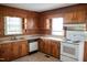 Traditional kitchen featuring wood cabinets, laminate countertops, and modern appliances at 5004 Us 70 Alt, Princeton, NC 27569