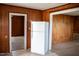 Clean white refrigerator in kitchen with wood paneled walls at 5004 Us 70 Alt, Princeton, NC 27569