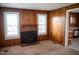 Inviting living room featuring a brick fireplace, wood-paneled walls, and ample natural light at 5004 Us 70 Alt, Princeton, NC 27569