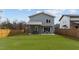 Spacious backyard featuring a covered patio area for outdoor dining and relaxation at 505 Colleton Rd, Raleigh, NC 27610