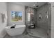 Modern bathroom featuring soaking tub, stylish glass enclosed shower, and sunlit view from the window at 505 Colleton Rd, Raleigh, NC 27610