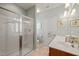 Bathroom featuring glass enclosed shower, double vanity, and warm lighting at 621 Aylestone Dr, Cary, NC 27519