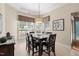 Cozy dining area with modern light fixture, large windows, and dark wood table with seating for six at 621 Aylestone Dr, Cary, NC 27519