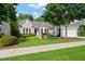 Charming single-story home with lush front lawn and colorful landscaping under mature shade trees at 621 Aylestone Dr, Cary, NC 27519