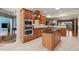 Eat-in kitchen features wood cabinets, stainless steel appliances, island, and breakfast bar open to the dining area at 621 Aylestone Dr, Cary, NC 27519