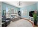 Beautiful living room with plenty of natural light, modern light fixture, light blue walls and hardwood floors at 621 Aylestone Dr, Cary, NC 27519