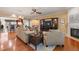 Open-concept living area with hardwood floors, fireplace, and views into the breakfast bar at 621 Aylestone Dr, Cary, NC 27519